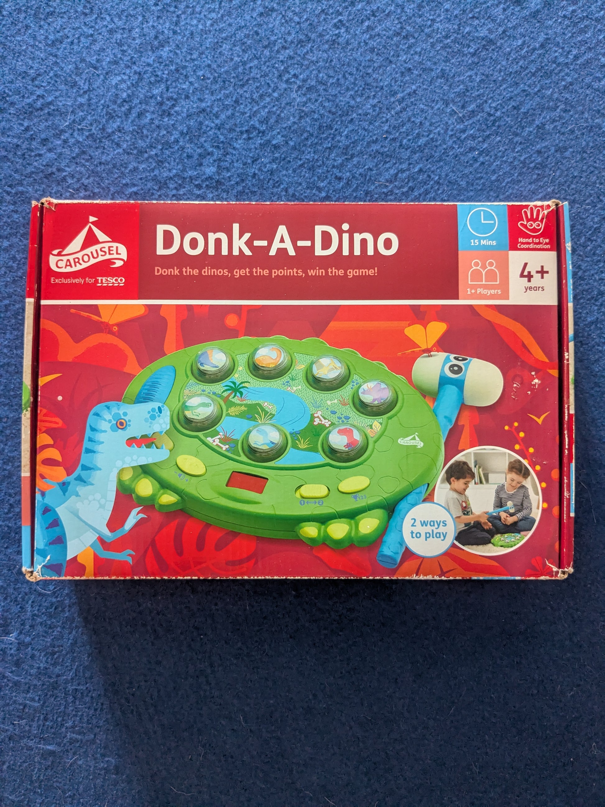 Board game box for 'Donk-A-Dino' on a blue background