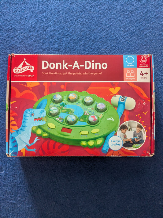 Board game box for 'Donk-A-Dino' on a blue background